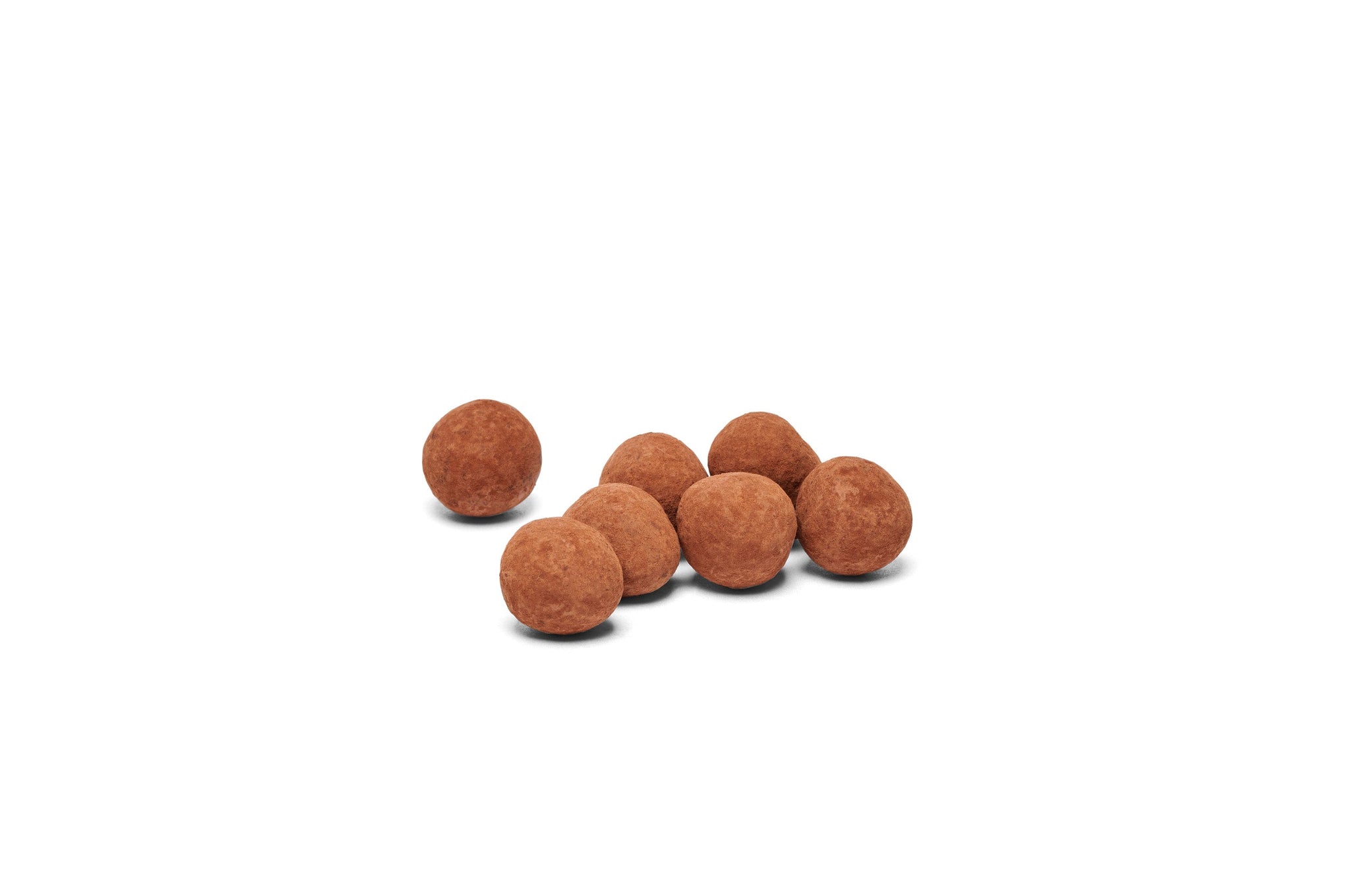 Chocolate dusted hazelnuts placed together